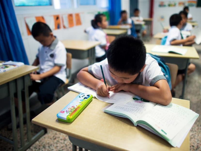 Seven year old Wei Yueran (left), who also has the English name Harney, attends a Chinese class at the Jinqao Center Primary School in Shanghai on Sept 1, 2014. Photo: AFP