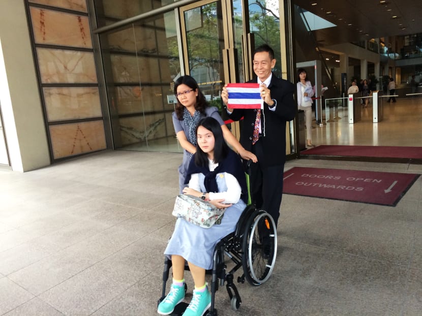 Ms Nitcharee, 18, with her father Kittanesh and an interpreter after her appeal. Photo: Neo Chai Chin