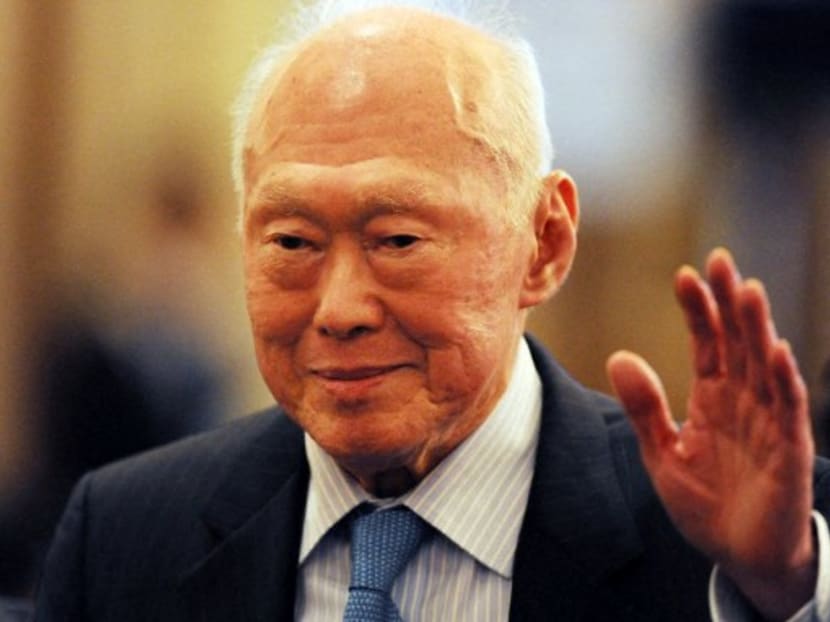 Singapore's former prime minister Lee Kuan Yew waves as he attends an event in Tokyo in 2011.