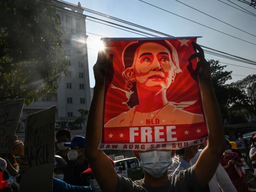 In this file photo taken on Feb 15, 2021, a protester holds up a poster featuring Aung San Suu Kyi during a demonstration against the military coup at in front of the Central Bank of Myanmar in Yangon. In this file photo taken on Feb 15, 2021, a protester holds up a poster featuring Aung San Suu Kyi during a demonstration against the military coup at in front of the Central Bank of Myanmar in Yangon.