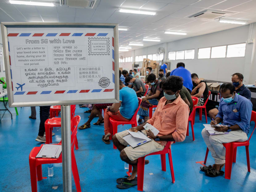 Migrant workers getting their second dose of the Covid-19 vaccine at CDPL Tuas Dormitory taking part in the letter writing initiative, “From SG with Love”, during their 30-minute rest period on April 11, 2021.