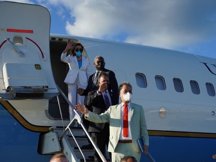 Mrs Nancy Pelosi (back of row), the United States House of Representatives Speaker, waving with other members of a delegation as they board a plane before leaving Taipei Songshan Airport, in Taipei, Taiwan, on Aug 3, 2022. Mrs Nancy Pelosi (back of row), the United States House of Representatives Speaker, waving with other members of a delegation as they board a plane before leaving Taipei Songshan Airport, in Taipei, Taiwan, on Aug 3, 2022.