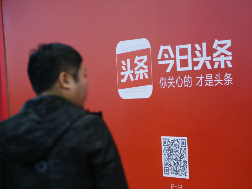 A man walks past an advertisement of Bytedance's news feed platform Toutiao, in Beijing, China. China has ordered Bytedance, to shut a popular joke-sharing app and delete its WeChat social media account, part of a resurgent effort to clean up online content.
