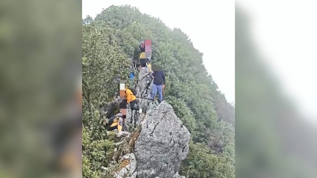 登山拍照不慎坠落40米高悬崖 中国男子无大碍感叹“福大命大”