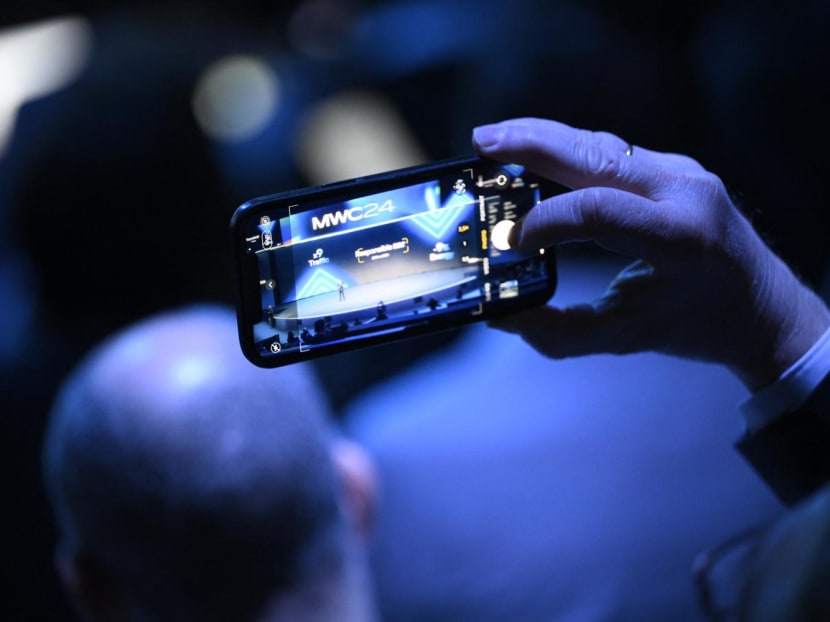 A visitor takes a picture while entering the Mobile World Congress (MWC), the telecom industry's biggest annual gathering, in Barcelona on Feb 26, 2024. A visitor takes a picture while entering the Mobile World Congress (MWC), the telecom industry's biggest annual gathering, in Barcelona on Feb 26, 2024.