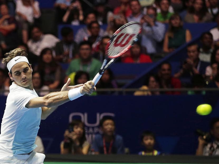 Tennis star Roger Federer playing at the International Premier League Tennis held at the Singapore Indoor Stadium. It is his first time here in Singapore. Photo: Wee Teck Hian