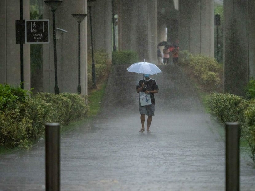 A man holds an umbrella while walking in the rain in Simei on March 2, 2020.