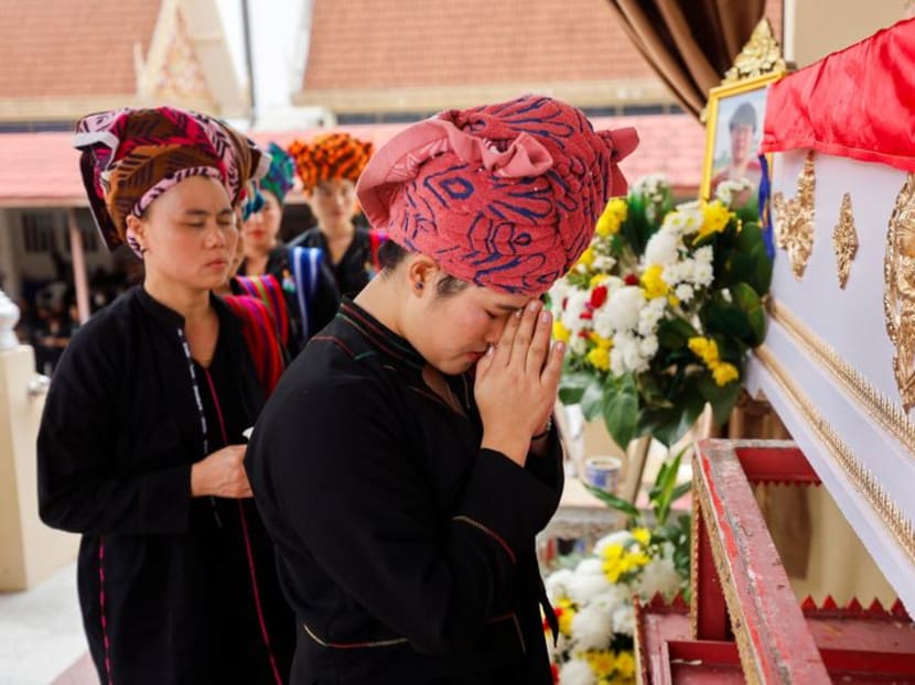Mourners attend the cremation ceremony of Moe Myint, a 31-year-old Burmese victim of the Thailand mall shooting, at a temple in Nonthaburi, Thailand, on Oct 8, 2023.