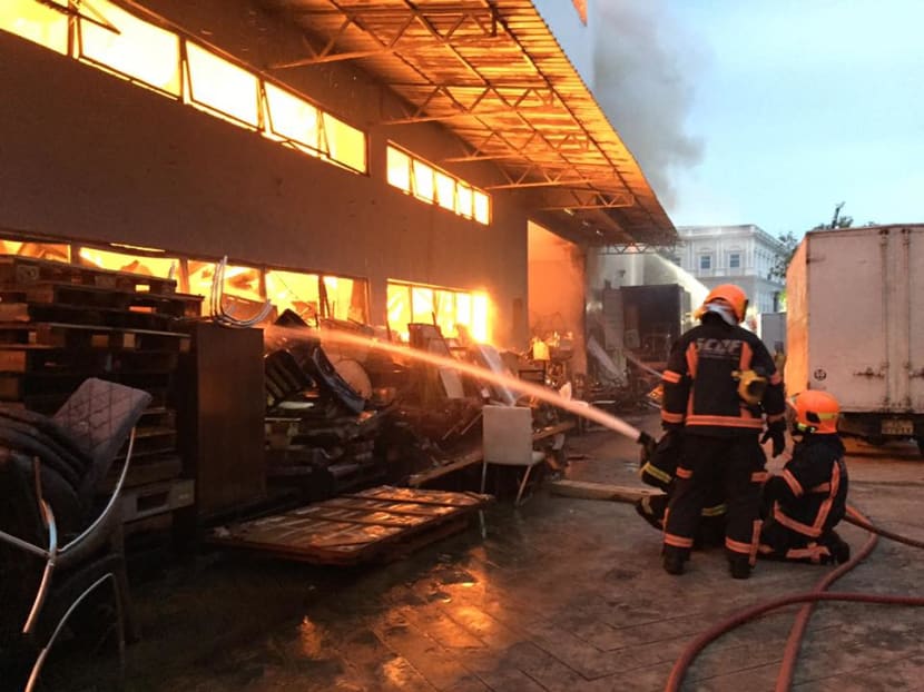 Firefighters putting out the fire that gutted a Sungei Kadut warehouse. Photo: The Singapore Civil Defence Force Firefighters putting out the fire that gutted a Sungei Kadut warehouse. Photo: The Singapore Civil Defence Force