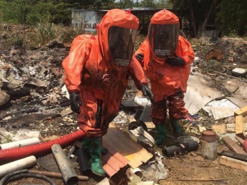 Personnel from the Johor Fire and Rescue Department’s Hazmat unit taking water samples along the Kim Kim River in Pasir Gudang, Johor.