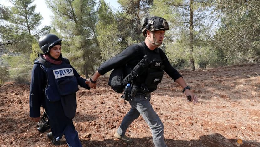 Israeli settlers attack Palestinians, journalists at West Bank olive harvest, witnesses say
