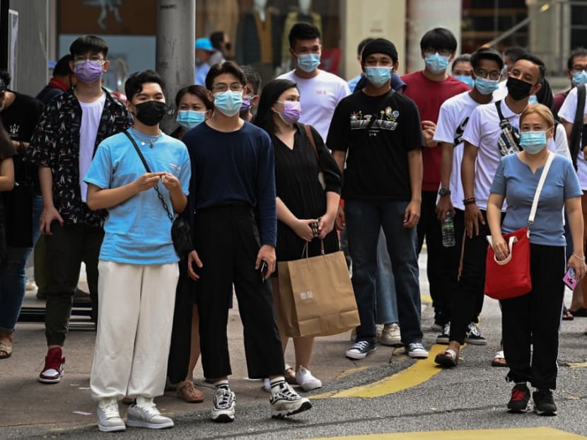 Poeple walk on a busy street in downtown Kuala Lumpur.