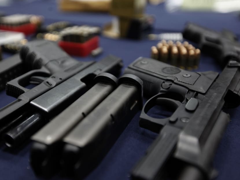 Firearms and ammunition seized from influential figures in Nakhon Pathom are displayed at a press briefing by the Crime Suppression Division and the Provincial Police Region 7.