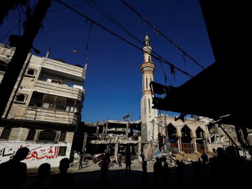 Palestinians stand near the site of an Israeli strike on a house, amid the ongoing conflict between Israel and the Palestinian Islamist group Hamas, in Rafah, in the southern Gaza Strip, April 17, 2024. 