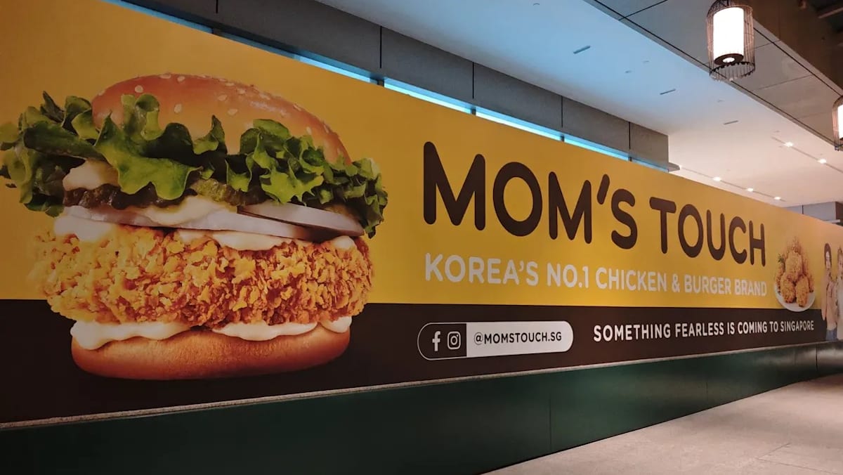 Korean fast food chain Mom’s Touch returning to Singapore, banner with K-pop group Le Sserafim seen at Chinatown