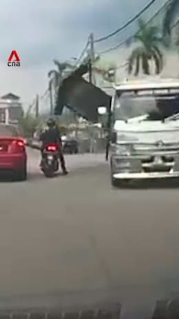 Motorcyclist in Malaysia injured after burger stall falls from lorry