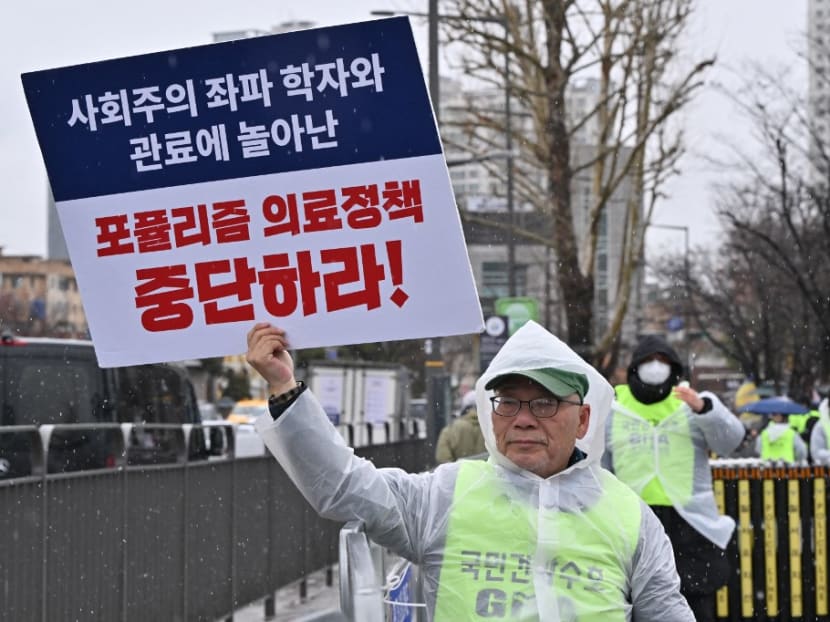 A doctor holds a placard reading "Stop populist medical policy!" during a rally to protest against the government’s plan to raise the annual enrolment quota at medical schools, near the presidential office in Seoul on Feb 21, 2024. A doctor holds a placard reading "Stop populist medical policy!" during a rally to protest against the government’s plan to raise the annual enrolment quota at medical schools, near the presidential office in Seoul on Feb 21, 2024.