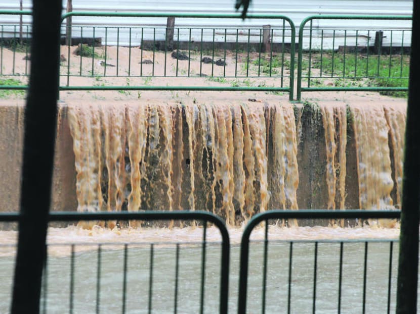Muddy water is seen pouring out from a construction site into the nearby canal as a result of heavy rain in 2010. TODAY file photo