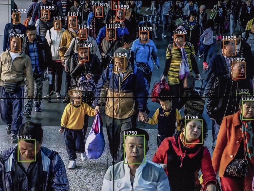 Monitors display a video showing facial recognition software in use at the headquarters of the artificial intelligence company in Beijing.