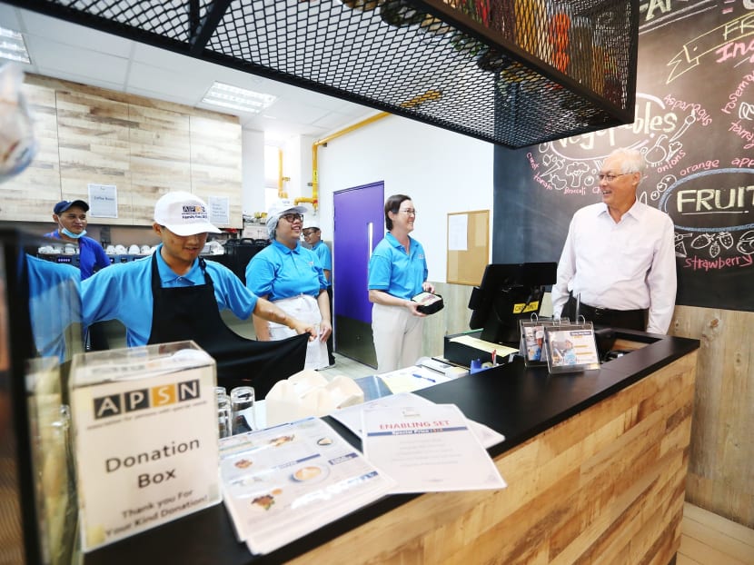 Emeritus Senior Minister Goh Chok Tong with the special-needs trainees who run the APSN Mystical Cafe For All. Photo: Koh Mui Fong