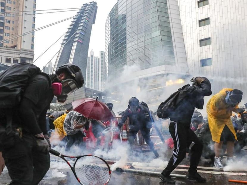Protesters defend themselves against tear gas in Tsuen Wan, Hong Kong, during a standoff with police on Aug 25, 2018.