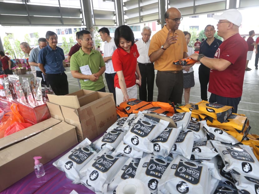 Social and Family Development Minister Desmond Lee, Senior Minister Tharman Shanmugaratnam and Senior Parliamentary Secretary for Home Affairs and National Development Sun Xueling at Project 100=50, an initiative by Heartwarmers Volunteer Group, where low- and middle-income households can come and buy S$100 worth of household products for S$50. Social and Family Development Minister Desmond Lee, Senior Minister Tharman Shanmugaratnam and Senior Parliamentary Secretary for Home Affairs and National Development Sun Xueling at Project 100=50, an initiative by Heartwarmers Volunteer Group, where low- and middle-income households can come and buy S$100 worth of household products for S$50.