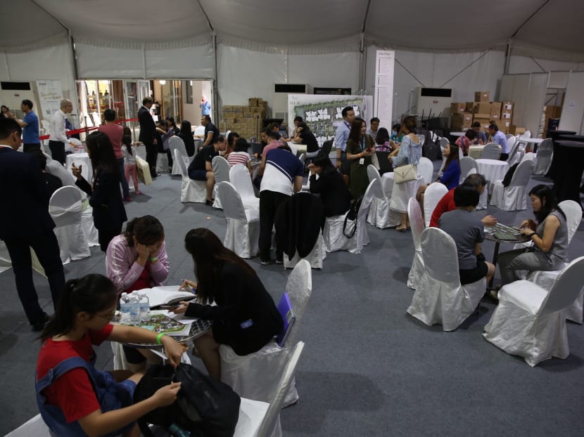 Potential buyers gather with representatives from the developer's agents at the Ola executive condominium's show gallery on March 19, 2020.