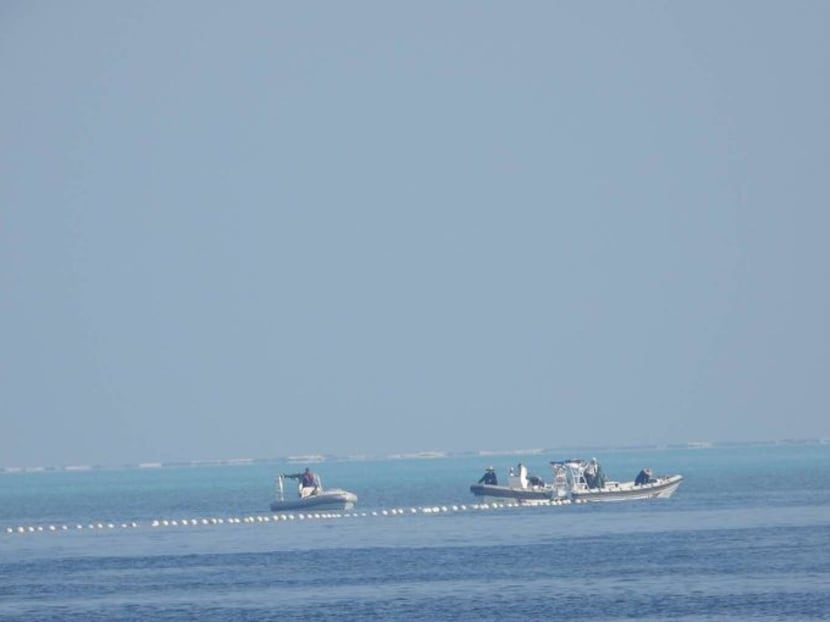 Chinese Coast Guard boats close to the floating barrier are pictured on Sept 20, 2023, near the Scarborough Shoal in the South China Sea, in this handout image released by the Philippine Coast Guard on Sept 24, 2023. Chinese Coast Guard boats close to the floating barrier are pictured on Sept 20, 2023, near the Scarborough Shoal in the South China Sea, in this handout image released by the Philippine Coast Guard on Sept 24, 2023.