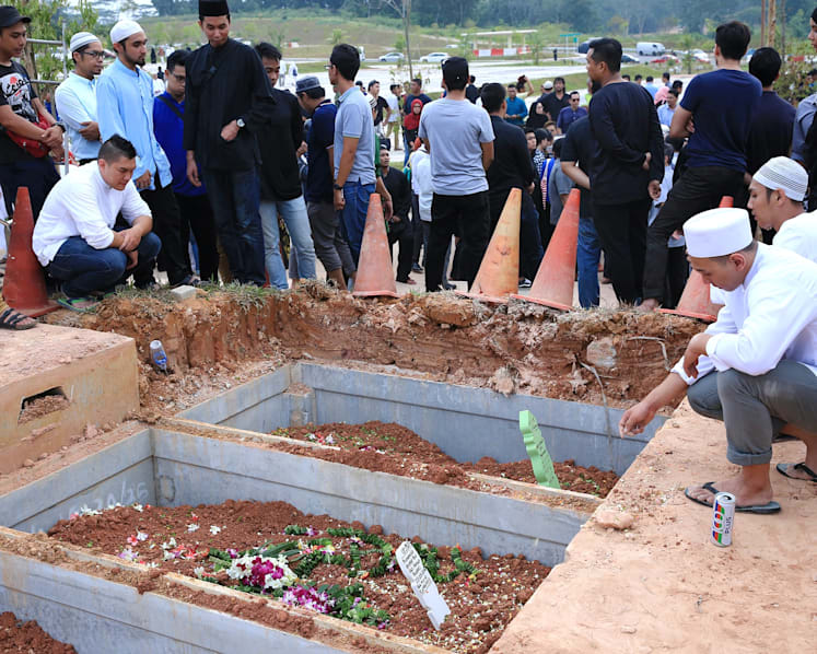 2 SMRT staff killed in accident laid to rest beside each other