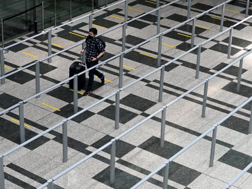 An arriving passenger walking to the taxi queue area in a terminal of Changi International Airport on Sept 11, 2020.