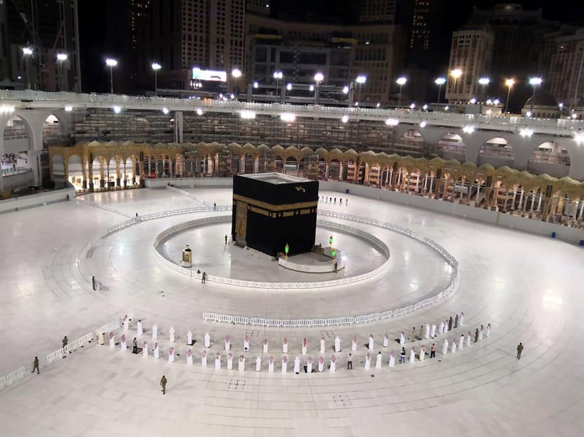 A small group of worshippers pray at Kaaba in the Grand Mosque while practicing social distancing during the holy month of Ramadan, in the holy city of Mecca, Saudi Arabia, May 4, 2020.