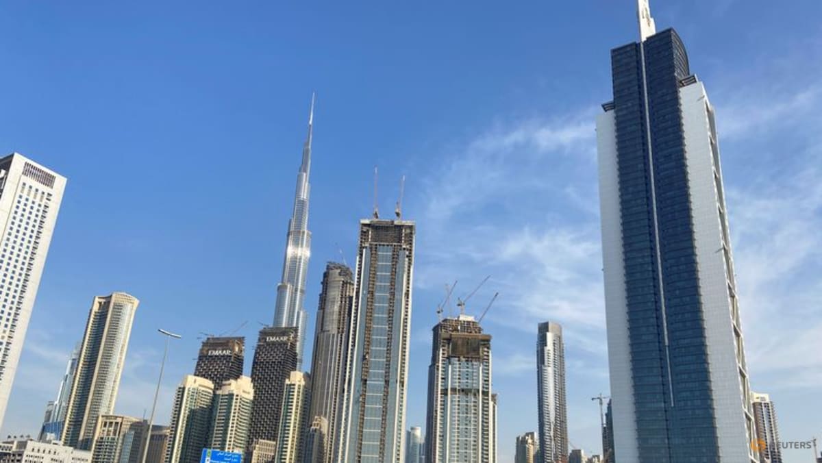 A dense collection of modern skyscrapers against a blue sky.