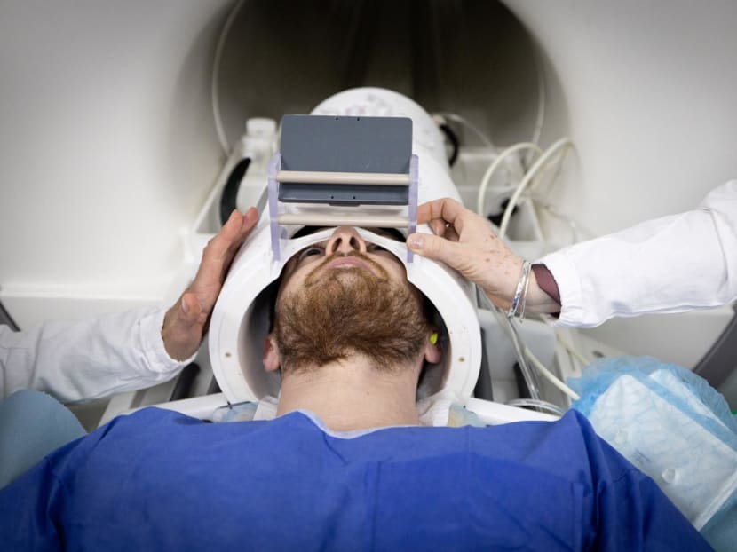 A volunteer takes part in a magnetic resonance imaging (MRI) exam simulation on the Iseult Magneton 11.7 T MRI at the Neurospin facilities in the Paris-Saclay Alternative Energies and Atomic Energy Commission centre in Gif-sur-Yvette, on March 22, 2024.