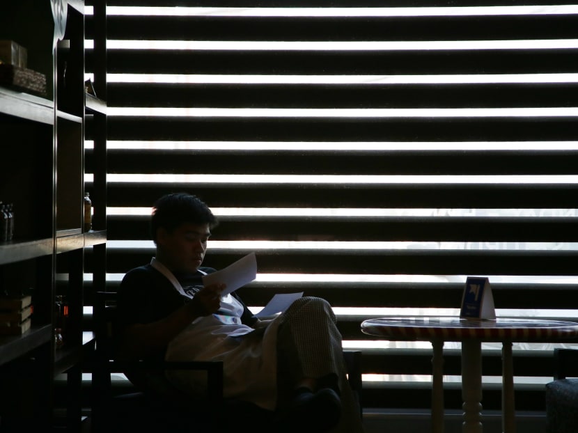 A trainee with autism reads instruction cards during his training at the Puzzle Cafe in suburban Quezon city, north of Manila, Philippines. AP file photo