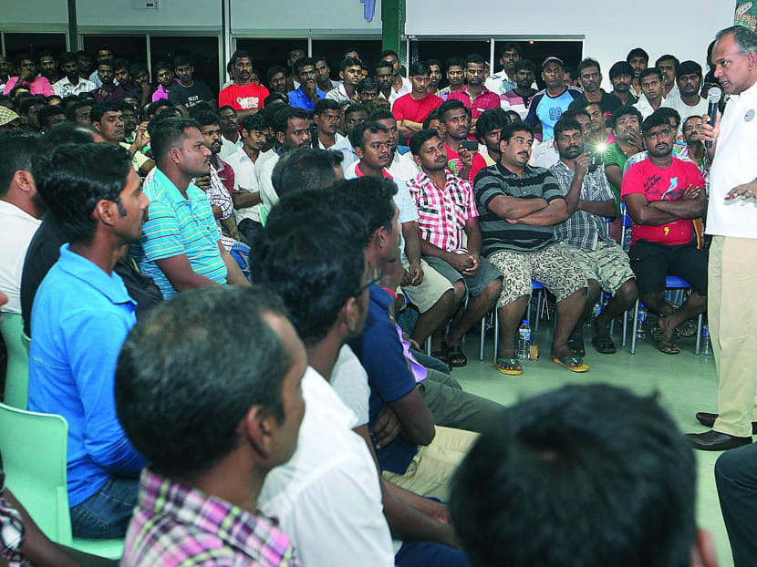 Mr Shanmugam speaking to foreign workers during his visit to their dormitories in Simpang Lodge 1 yesterday. Photo: Ooi Boon Keong