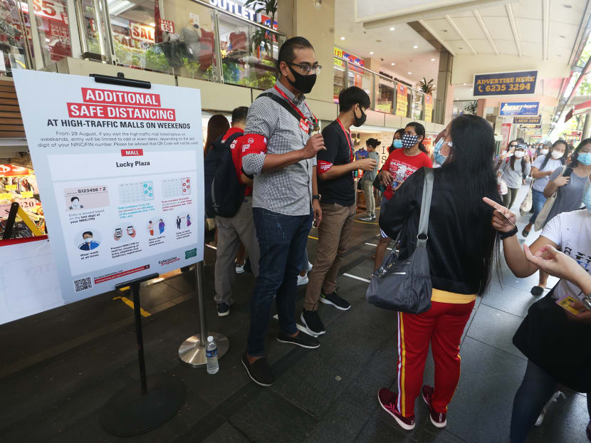 Safe-distancing enforcement officers checking the National Registration Identity Cards and Foreign Identification Numbers of visitors entering Lucky Plaza shopping centre on Sept 6, 2020. Safe-distancing enforcement officers checking the National Registration Identity Cards and Foreign Identification Numbers of visitors entering Lucky Plaza shopping centre on Sept 6, 2020.