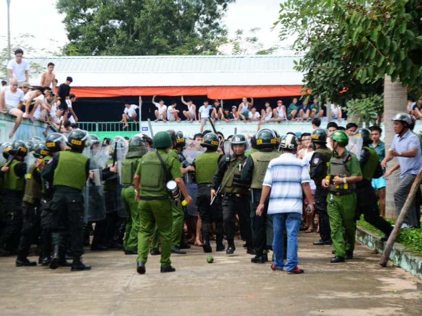 Policemen try to prevent drug addicts from escaping a compulsory rehabilitation centre in the southern province of Dong Nai, Vietnam on Nov 7, 2016. 