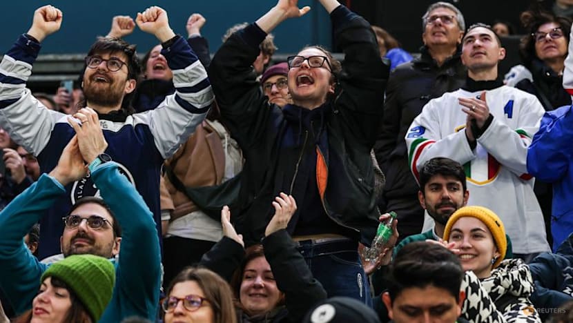 Ice hockey-Italian fans keep party going despite heavy defeat by Sweden