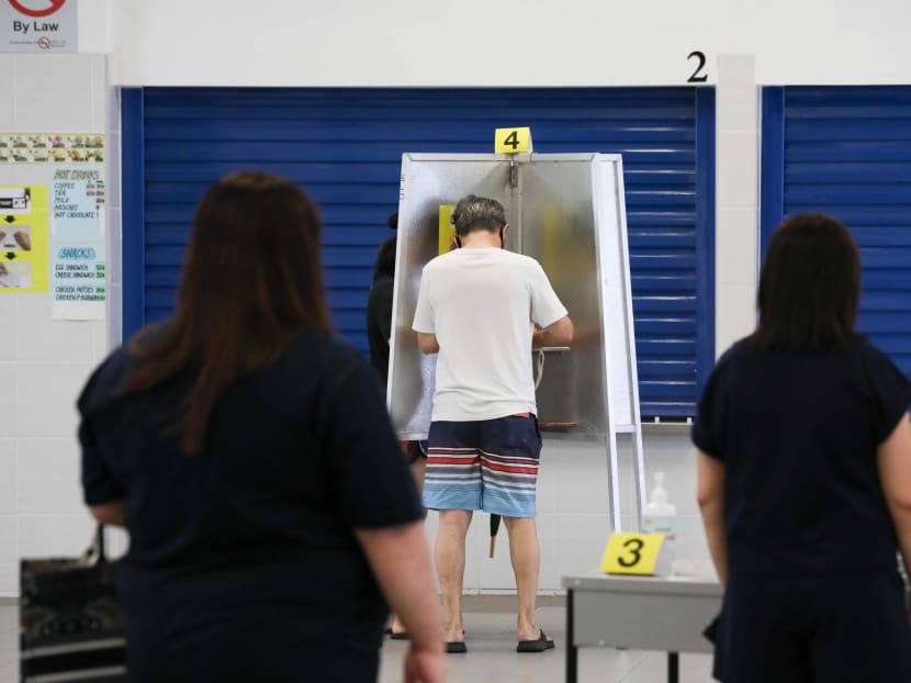 Voters casting their ballots at a polling station in Dunearn Secondary School on July 10, 2020.
