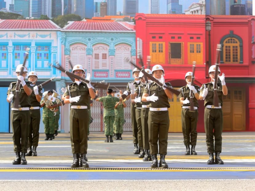 A file photo of some members of Singapore's military police performing a rifle stunt at a media preview of the Army Open House. A file photo of some members of Singapore's military police performing a rifle stunt at a media preview of the Army Open House.