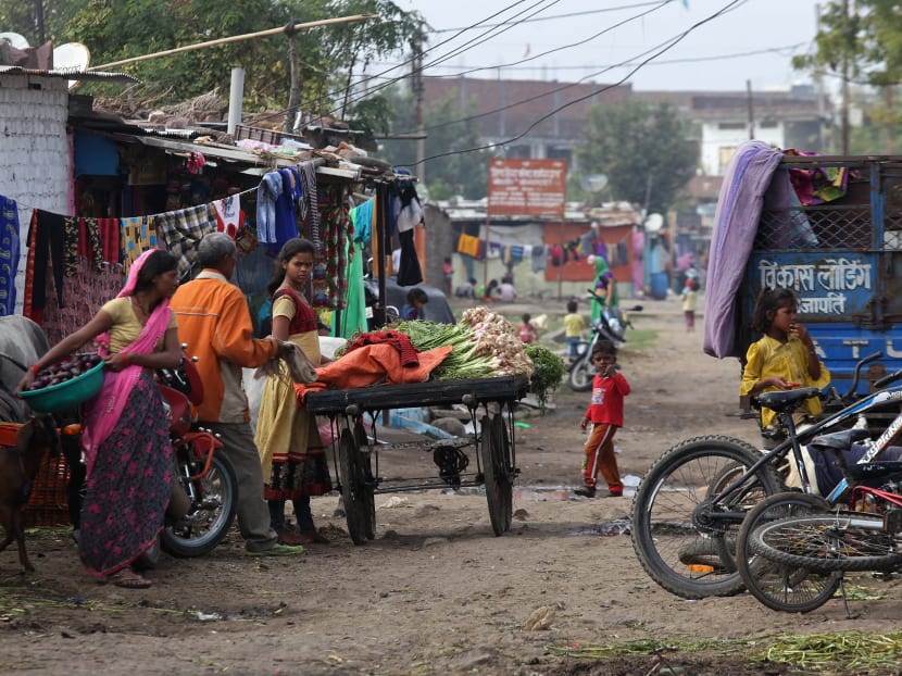 In this picture taken on Jan 8, 2021, a vegetable vendor stands at the Oriya Basti slum in Bhopal. A homegrown coronavirus vaccine will be rolled out in India from Jan 16 even though clinical trials haven't been completed. But the government insists it will be safe and effective.