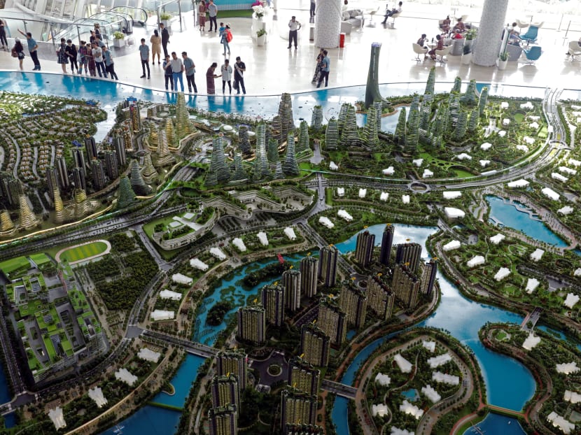 Prospects look at a model of the development at the Country Gardens' Forest City showroom in Johor Bahru, Malaysia on Feb 21, 2017. Prospects look at a model of the development at the Country Gardens' Forest City showroom in Johor Bahru, Malaysia on Feb 21, 2017.