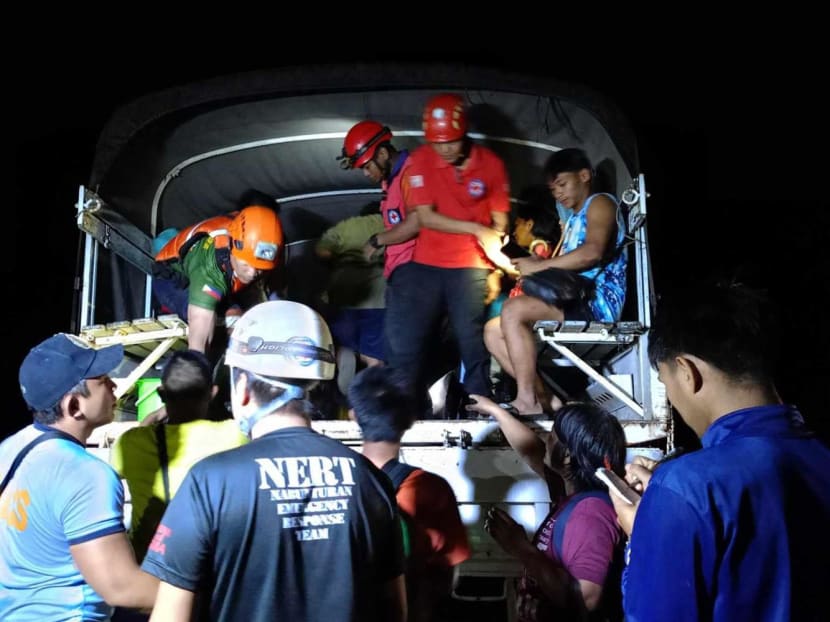 This handout photo taken on Feb 6, 2024 and released on Feb 7 by the Philippine Red Cross shows personnel arriving for search and rescue operations following a landslide in Maco municipality in Davao de Oro province in the Philippines.