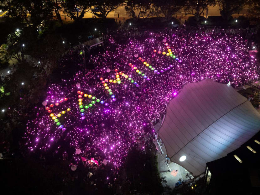 The formation of the word family using torchlights at the Pink Dot event at Hong Lim Park on June 24, 2023