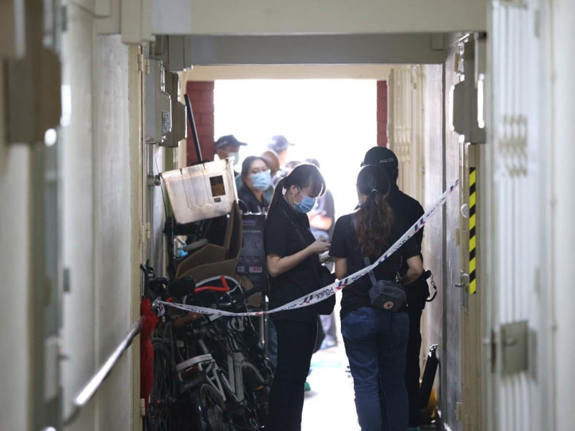 Police officers outside the scene of a murder at a housing block along Redhill Close on March 17, 2023.
