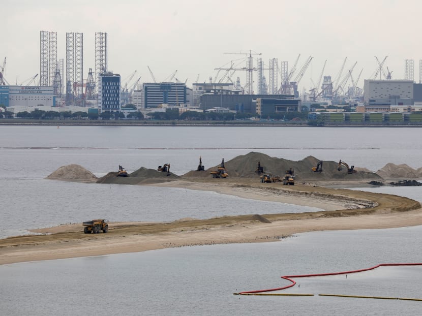 Trucks carry sand at land reclamation area overlooking Singapore's Tuas industrial area. In its statement, the Ministry of Transport expressed "grave concern" over Malaysia's move to expand the Johor port limits, which encroach into Singapore's territorial waters off Tuas.