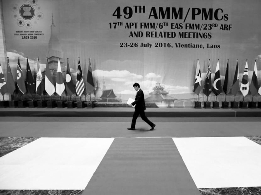 A man walking past a banner at the Asean Foreign Ministers’ Meeting in Vientiane on July 25. Events over the past few months make one ponder if the Asean member states understand and accept their responsibilities and obligations as members. Photo: REUTERS