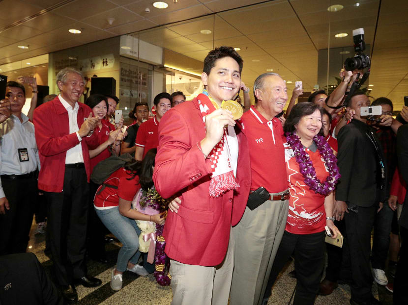 Joseph Schooling poses with his parents at Changi Airport on Aug 14. TODAY file photo.