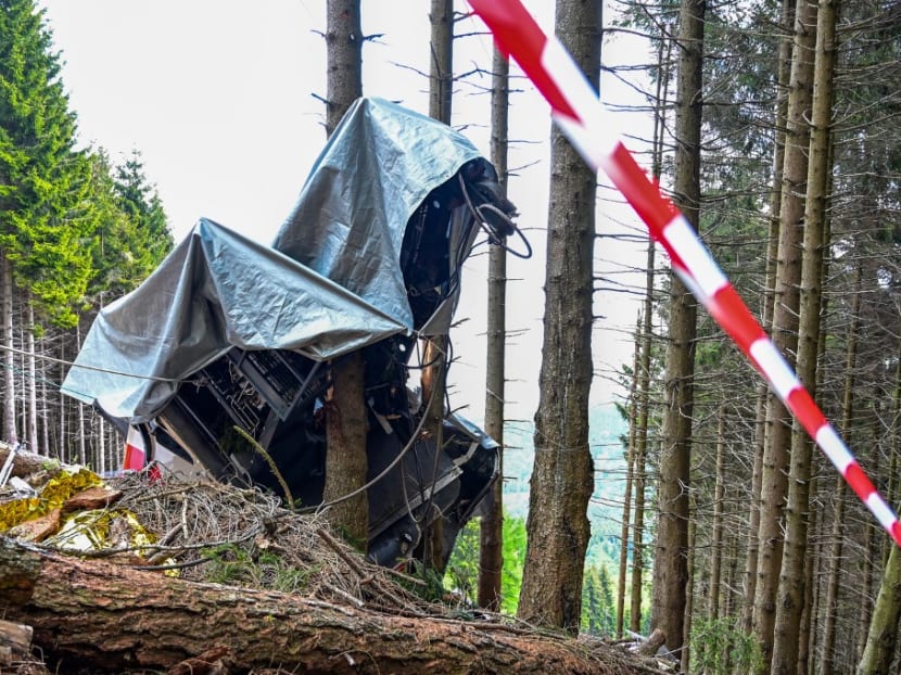 A view of a cable car's wreckage covered with a tarpaulin on May 26, 2021 on the slopes of the Mottarone peak above Stresa, Piedmont, three days after a cable car crash that killed 14 people.