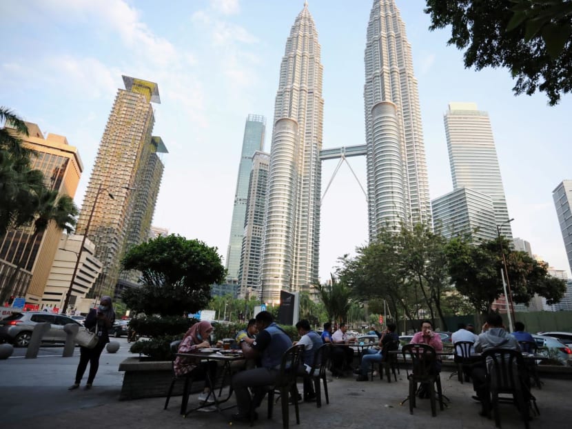 People dine in at a restaurant in front of Petronas Twin Towers in Kuala Lumpur, Malaysia on Nov 5, 2020. 